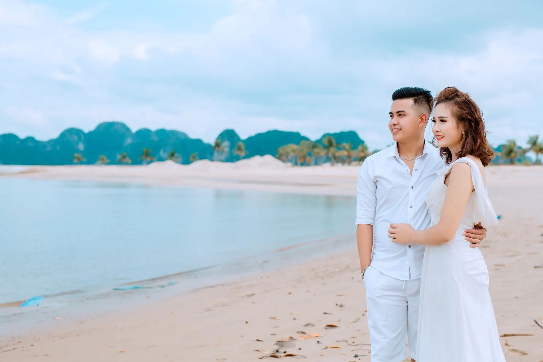 A couple on a beach, the kind of moment you hand your phone over for